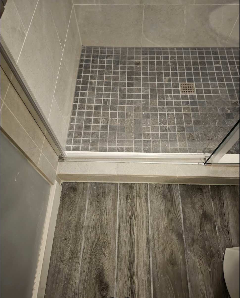 Bathroom remodel showcasing clean tile work and flooring