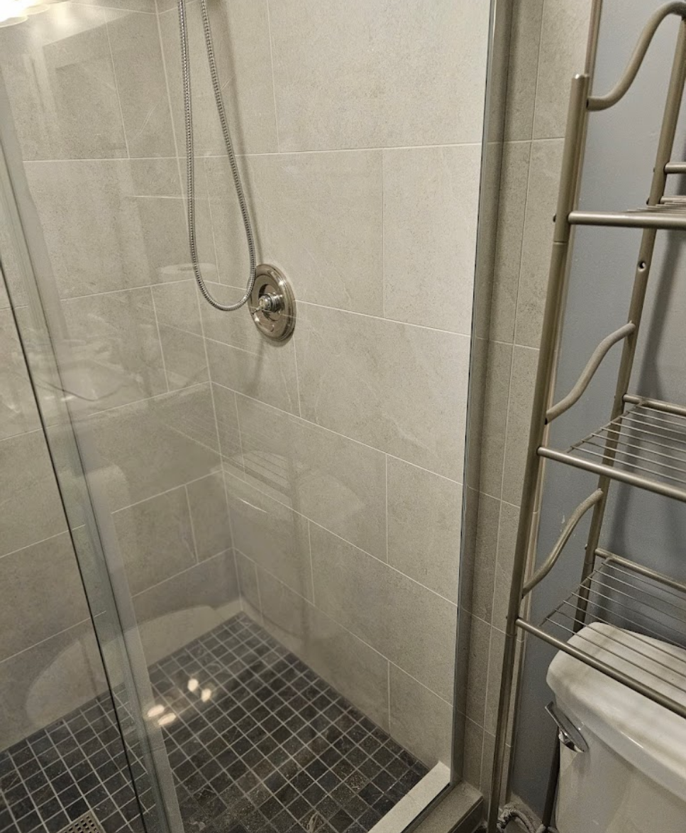 Updated shower area with glass doors and minimalistic design