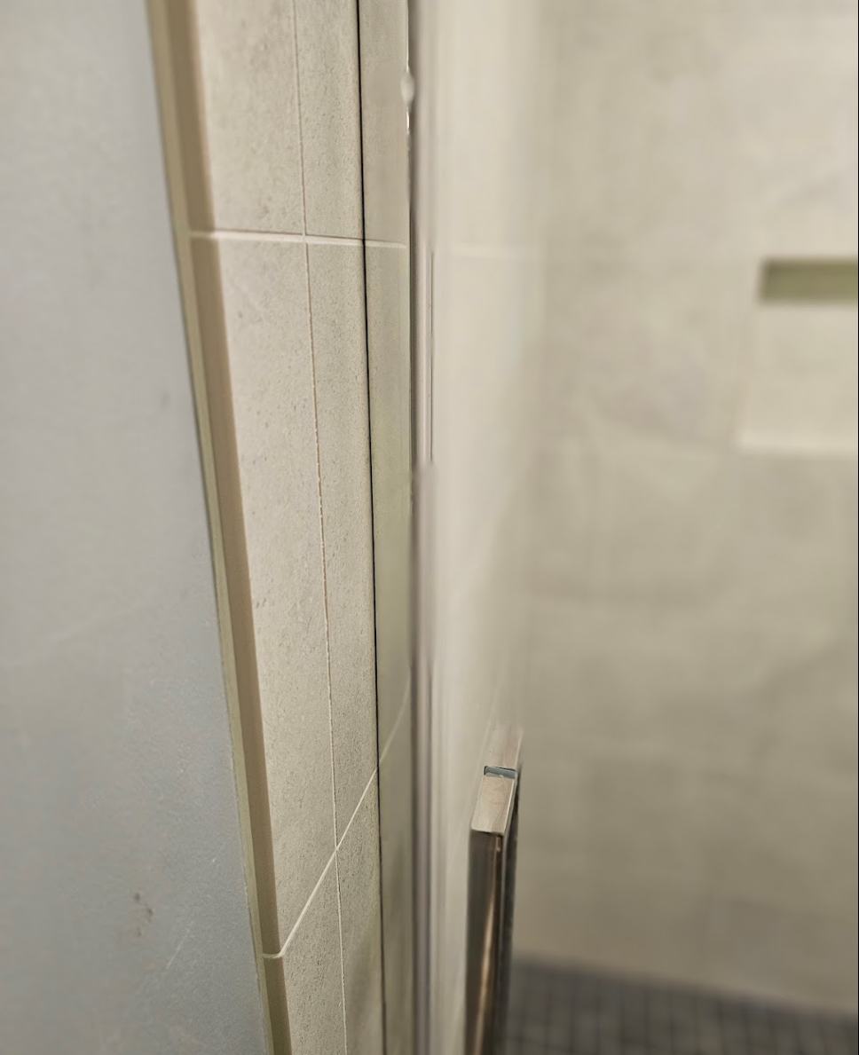 Close-up of premium glass doors in a remodeled bathroom