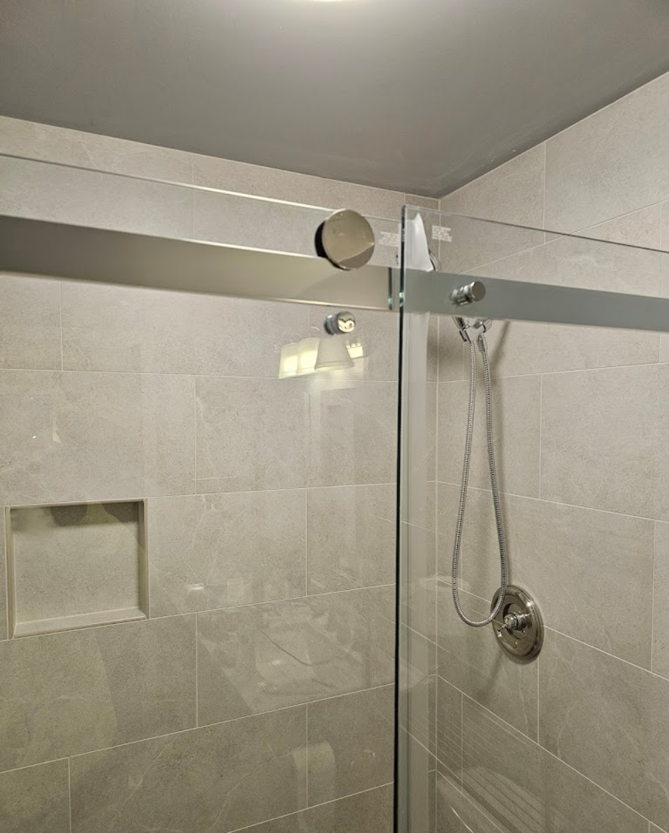 Sleek bathroom shower with glass doors and modern tiles