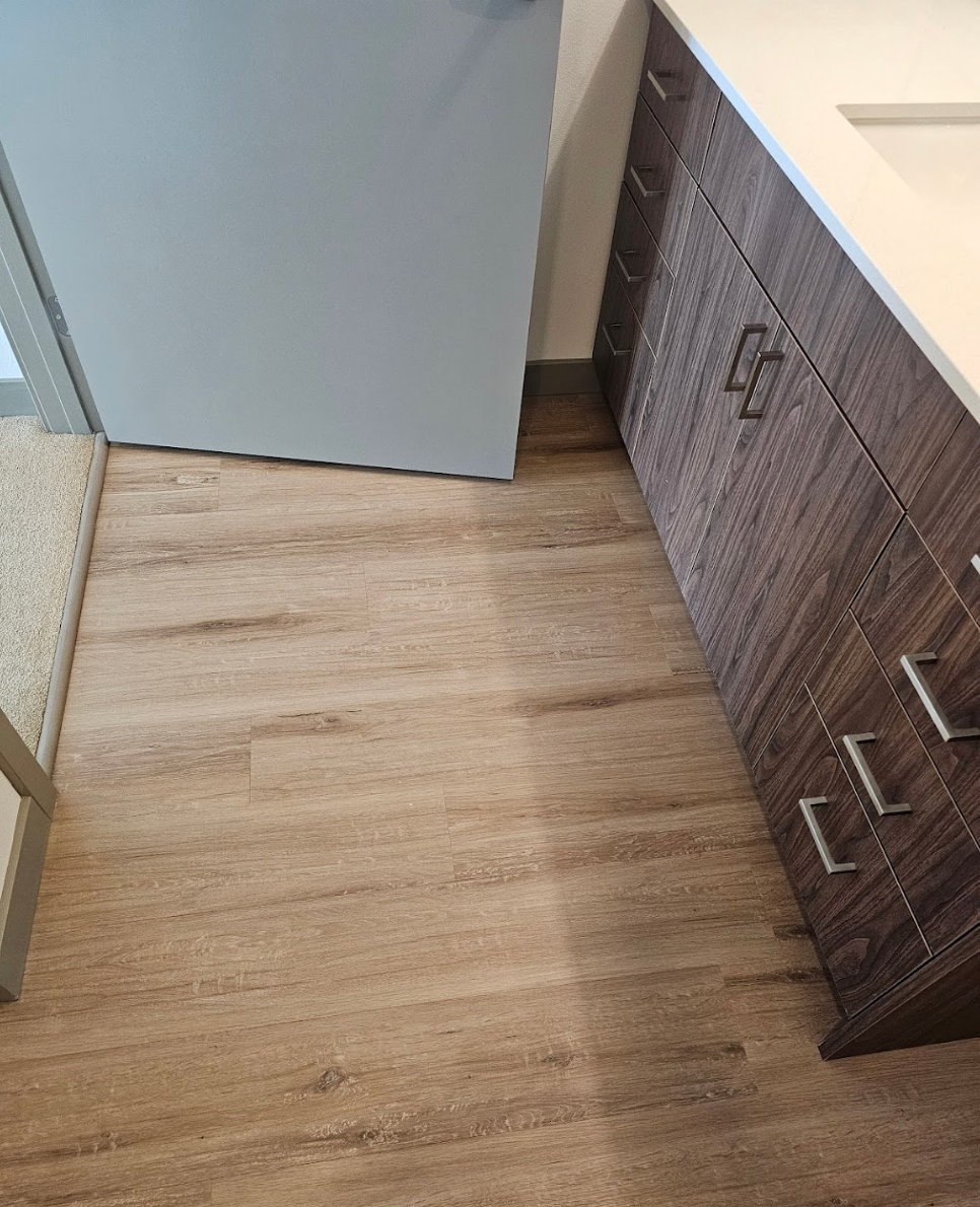 Bathroom with wood-inspired flooring and stylish vanity