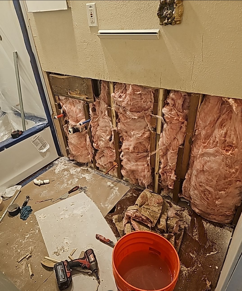 Exposed walls and plumbing during a bathroom renovation