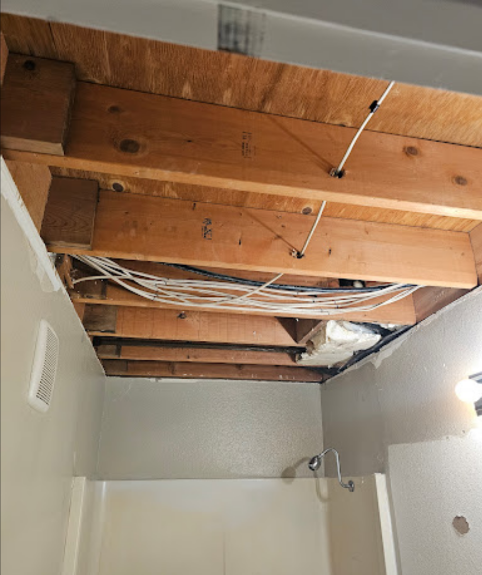 Bathroom ceiling renovation with exposed wooden beams