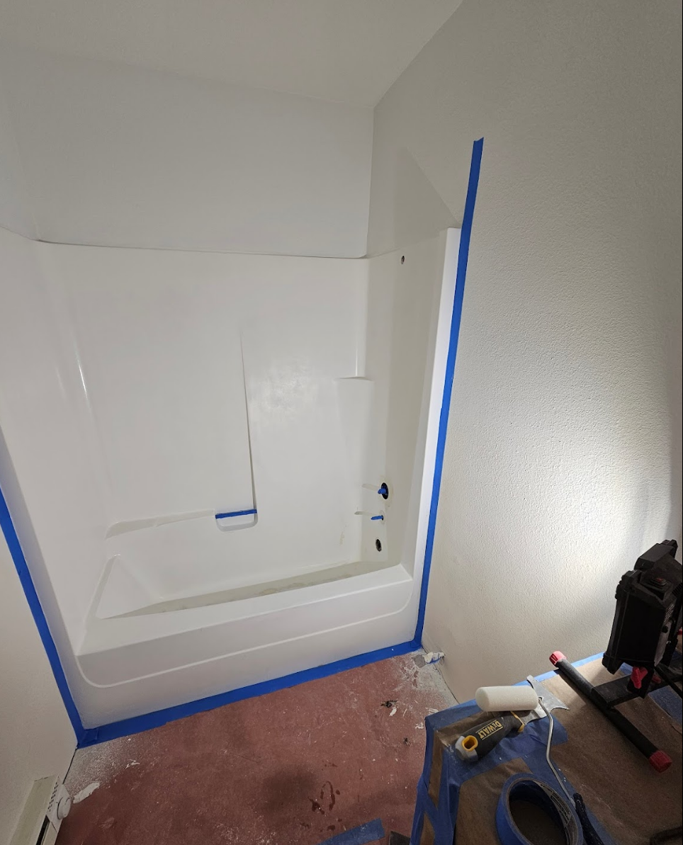 Shower installation in progress with protective masking