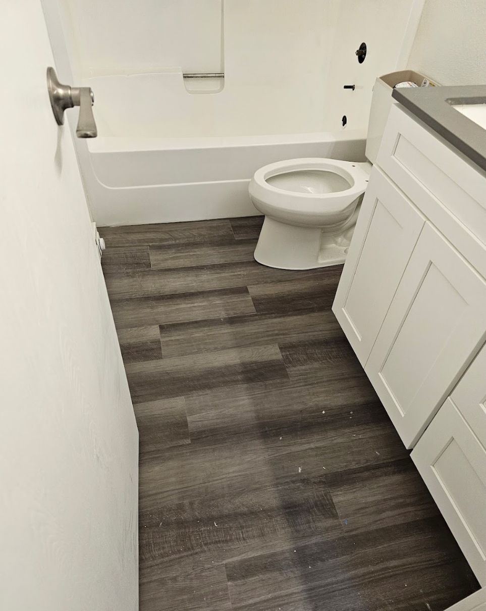 Modern bathroom featuring elegant flooring and white fixtures