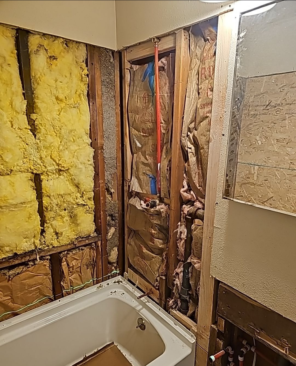 In-progress bathroom renovation with exposed walls and insulation