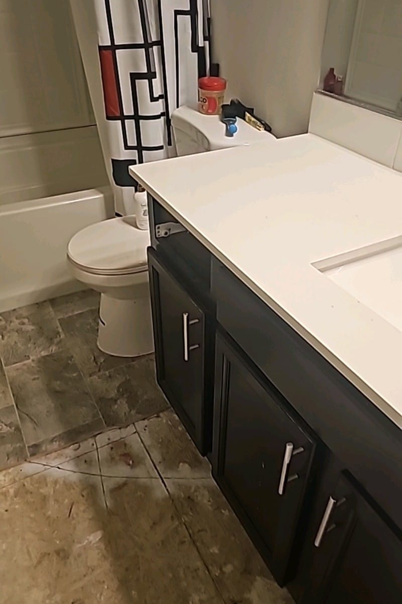 Bathroom renovation showcasing updated cabinets and clean layout