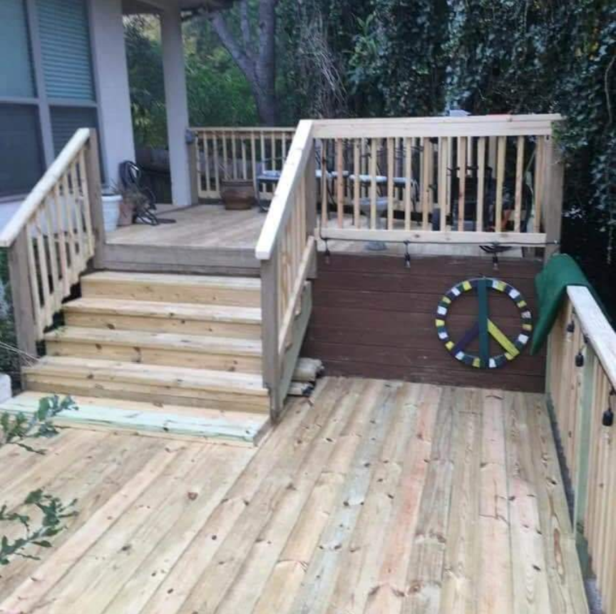 Completed wooden deck with stairs and railing