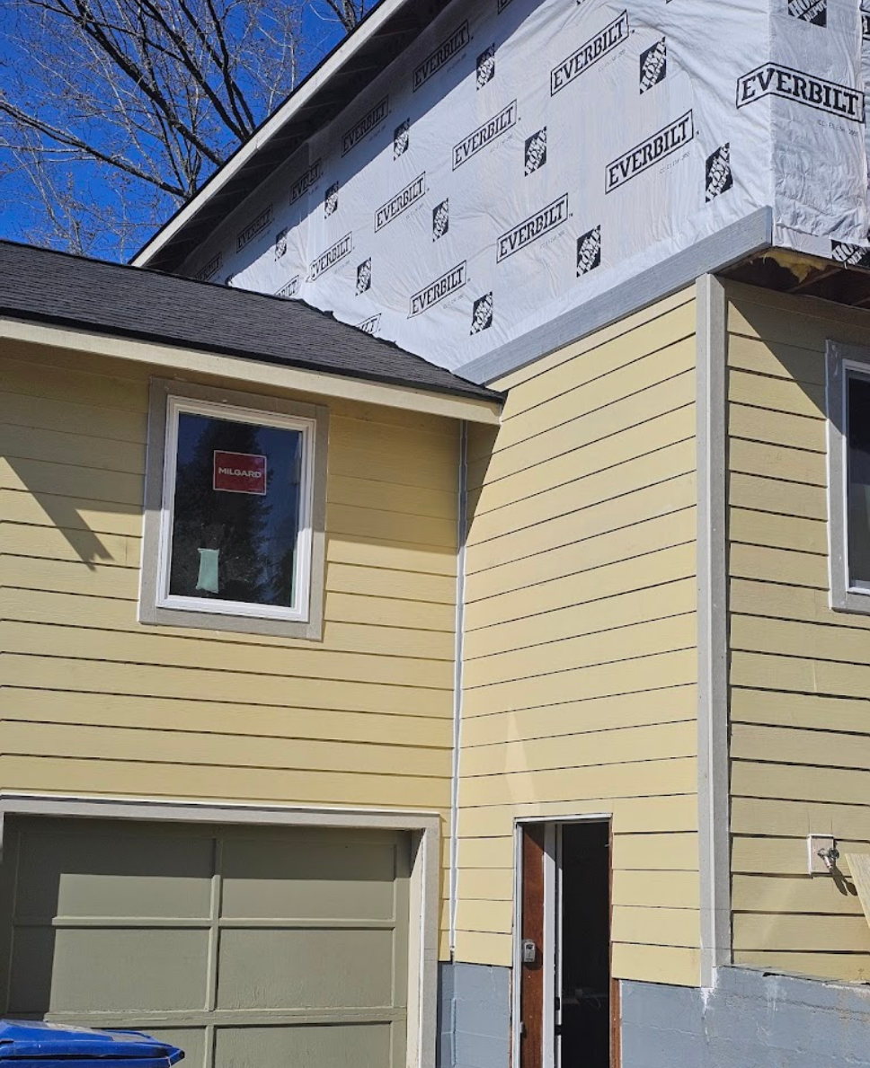 Ongoing exterior remodelation with fresh yellow siding