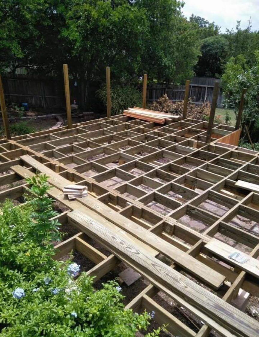 Decking frame installation in a green backyard