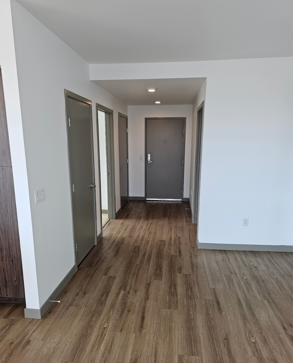 Hallway showcasing sleek and modern wood flooring