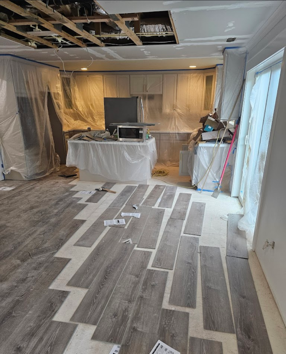 Unique zigzag patterned flooring in an open kitchen layout