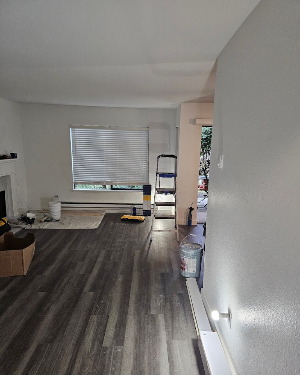 Living room with sleek gray flooring and bright natural lighting