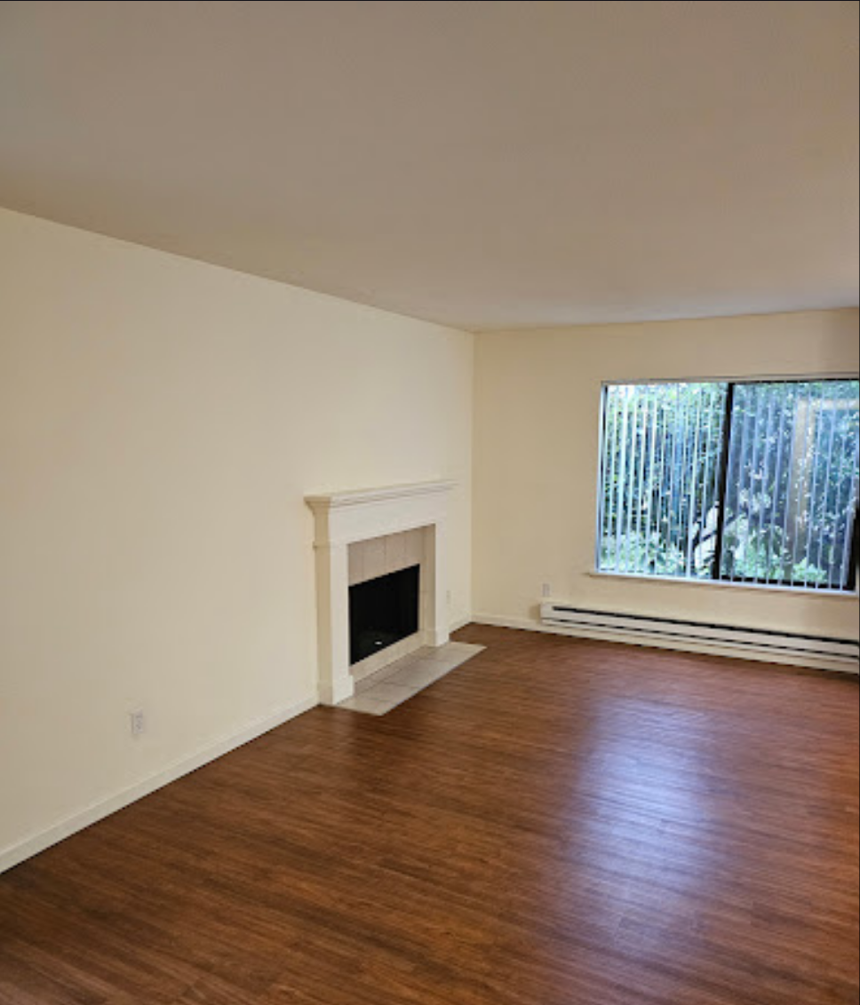 Living room with newly installed hardwood flooring and fireplace