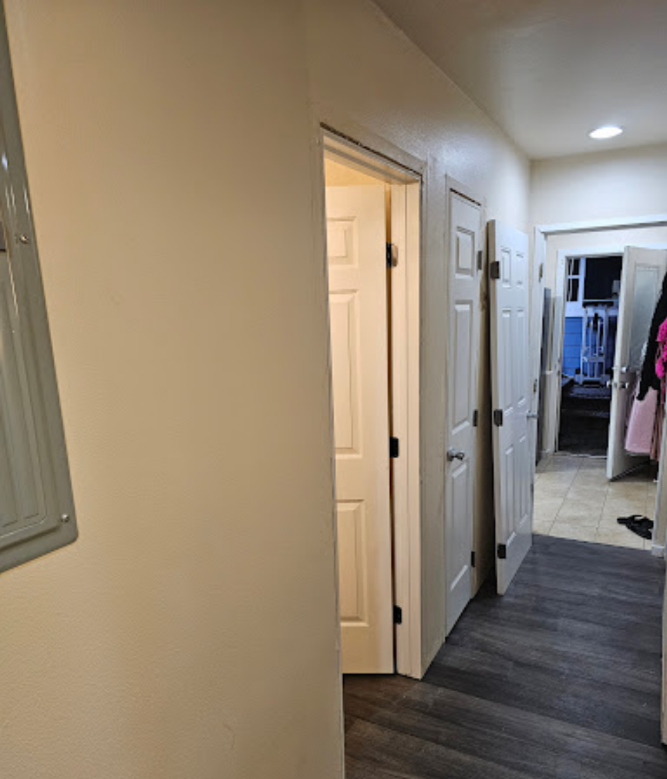 Hallway with upgraded lighting and modern flooring