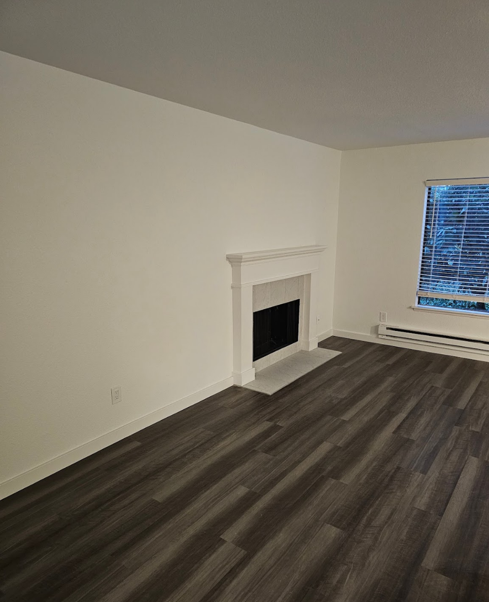 Spacious living room with modern flooring and natural light