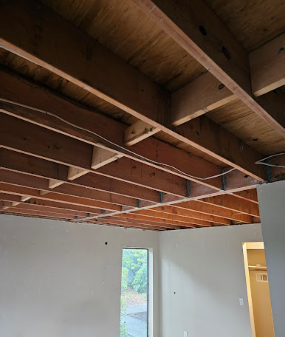 Ceiling renovation with exposed beams and structural work