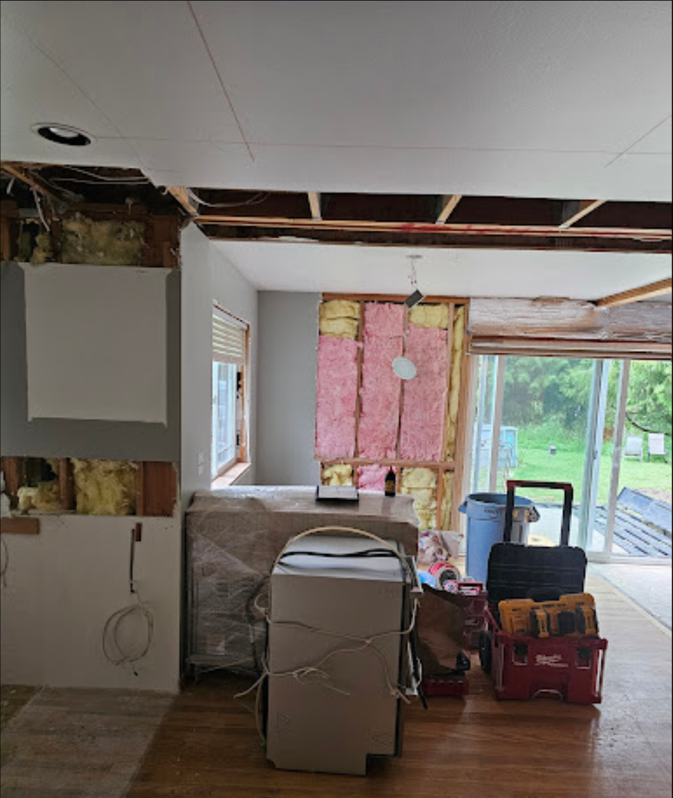 Interior remodeling showing open layout and exposed beams