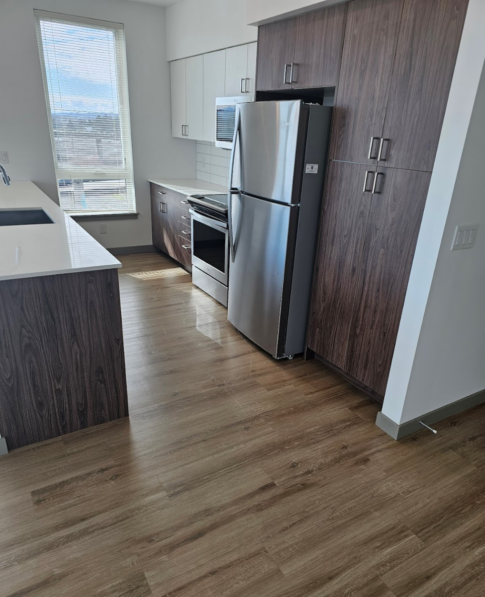 Modern kitchen with wooden finishes and stainless steel appliances