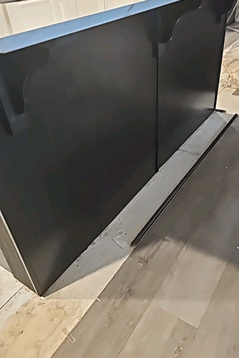 Side view of kitchen island with sleek black cabinets